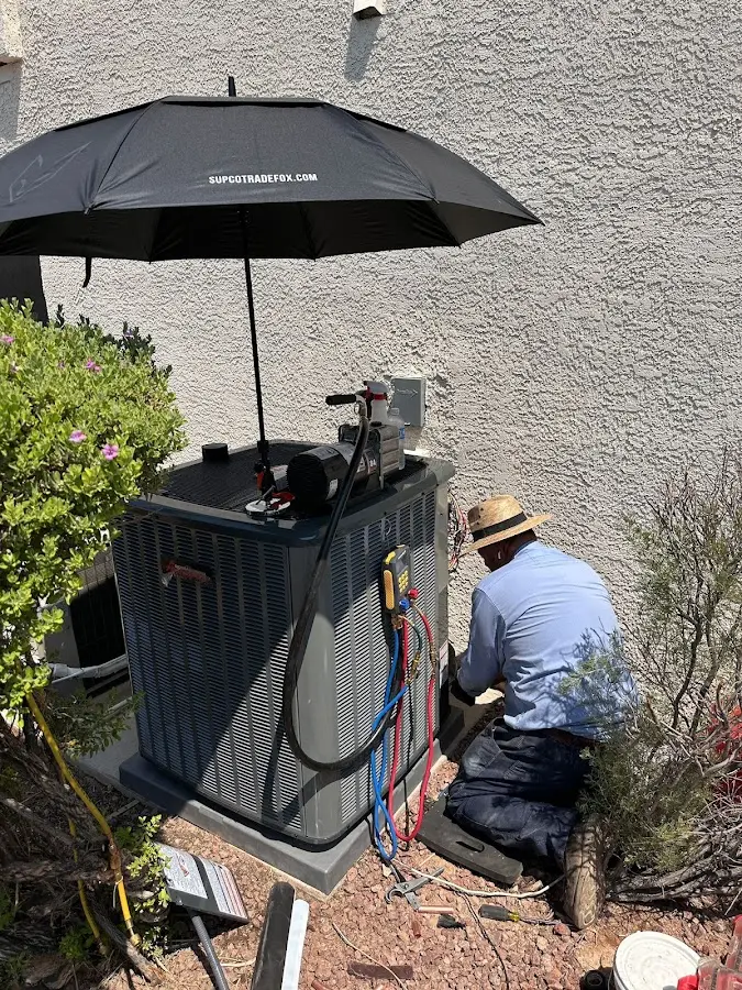 HVAC technician performing outdoor AC maintenance in Prairie View