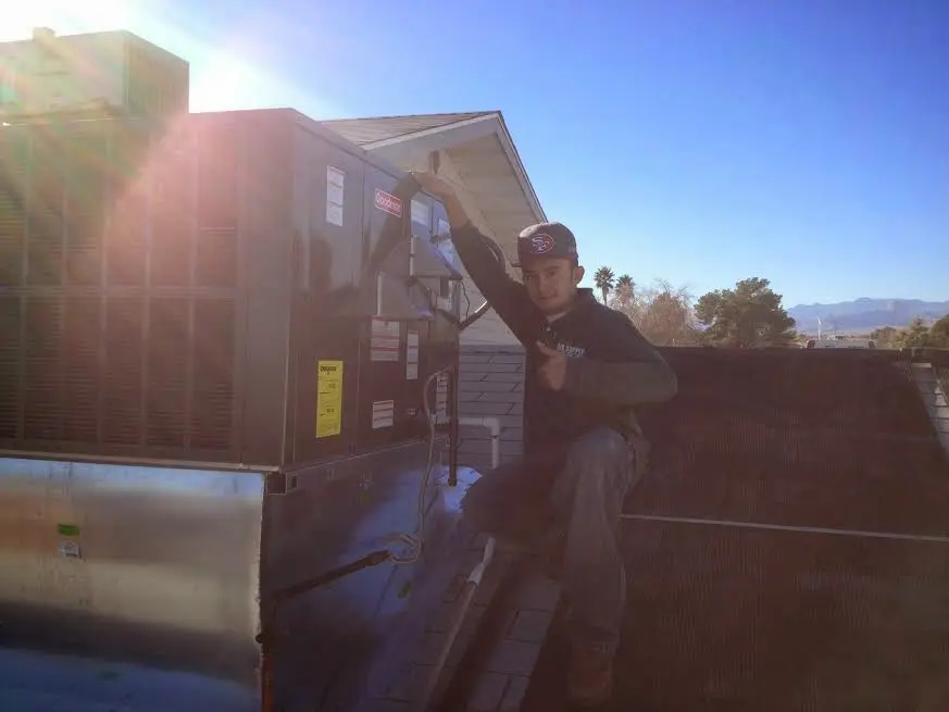 HVAC technician performing HVAC Inspection on a rooftop unit in Prairie View